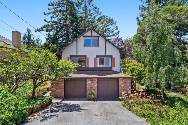 a front view of a house with garden