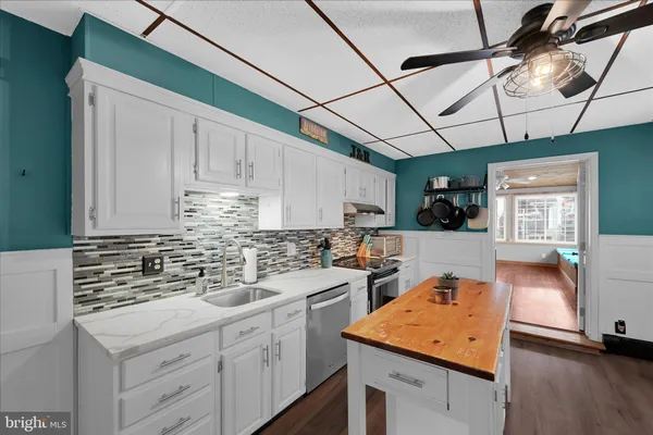 a kitchen with a sink stove and cabinets