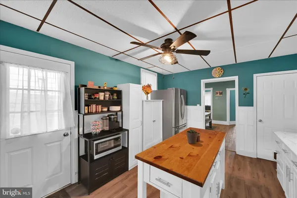 a kitchen with stainless steel appliances granite countertop a refrigerator and a stove