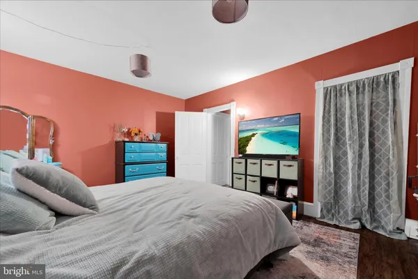 a bedroom with a large bed and a window