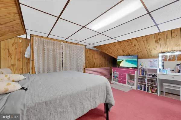 a bed room with a bed and a chair