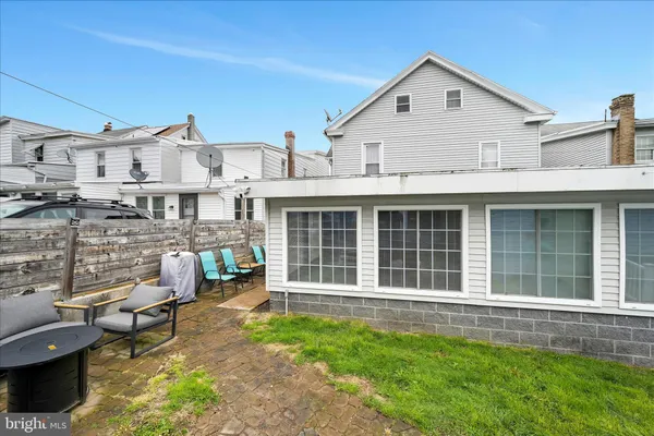 a view of a house with a yard and sitting area