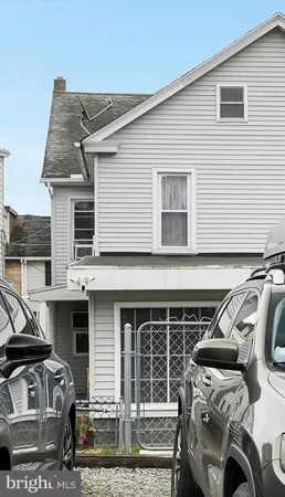 a front view of a house with parking space