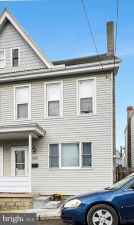 a front view of a house with parking space
