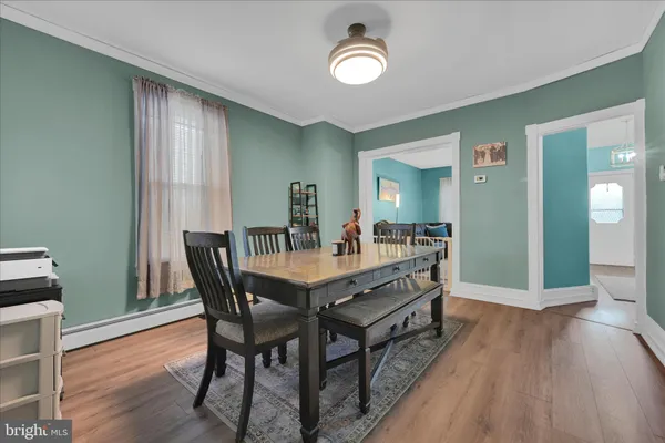 a view of a dining room with furniture and wooden floor