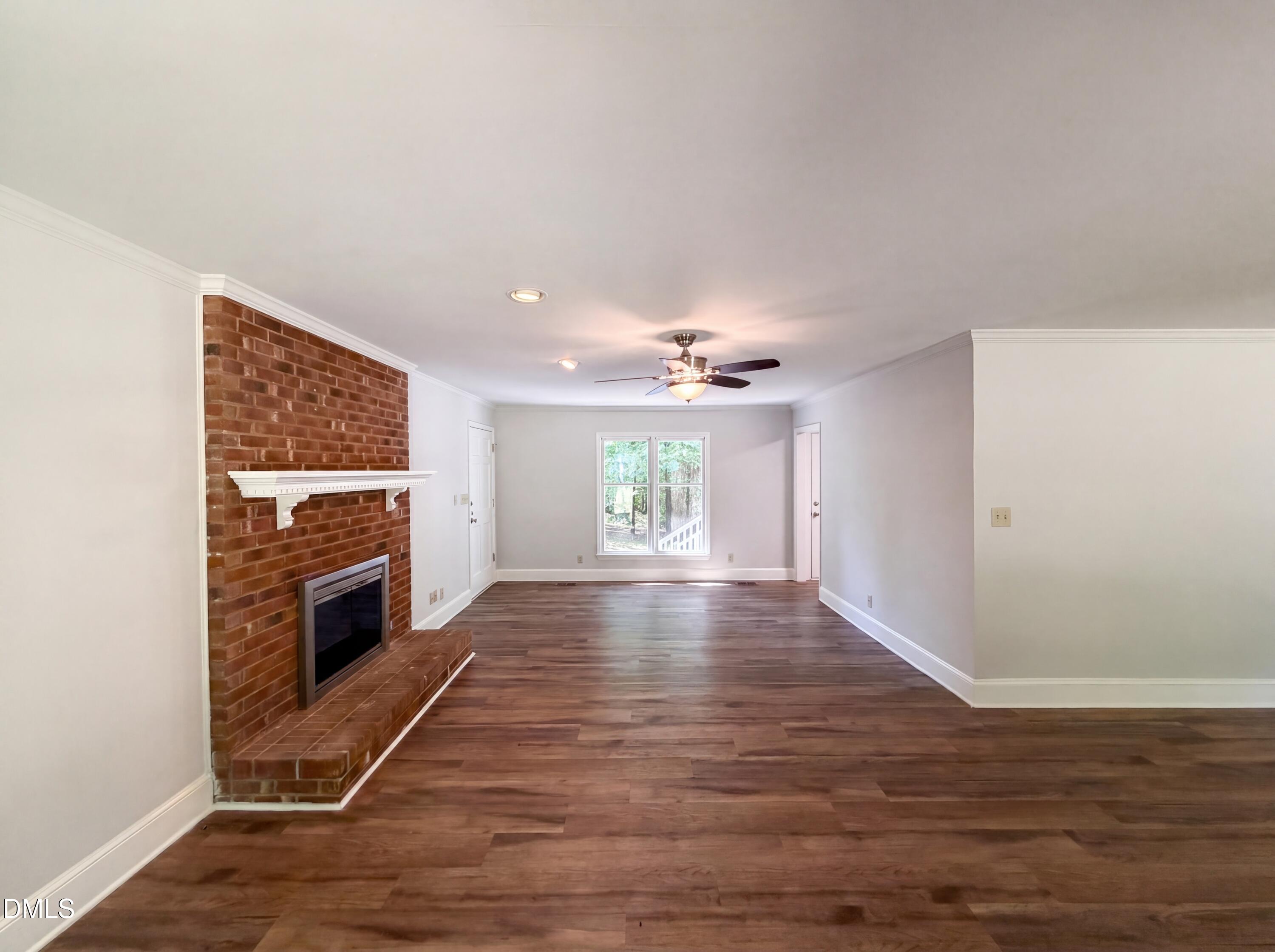 102 Lakeside Farm Road Zebulon, NC 27597 - Photo 5 of 18 wooden floor in an empty room with a fireplace