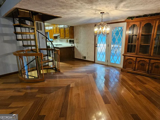 a view of a livingroom with furniture wooden floor and windows