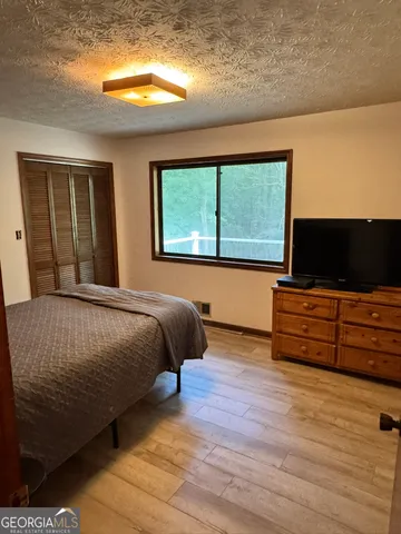 a bedroom with a bed and flat screen tv
