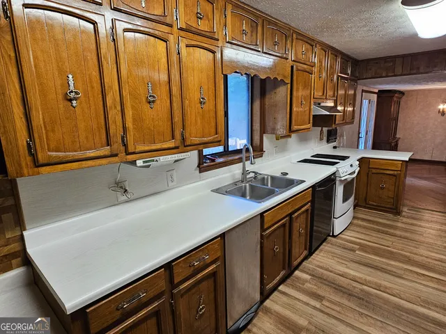 a kitchen with stainless steel appliances granite countertop a refrigerator and a sink