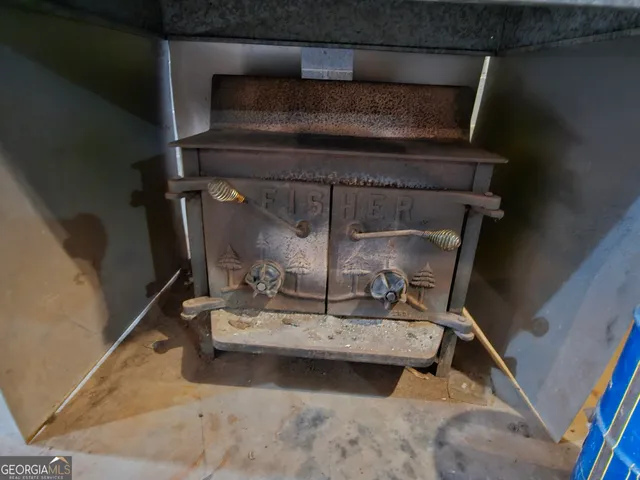 a view of a patio with table and chairs near a yard
