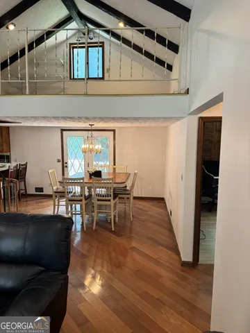 a dining room with furniture and wooden floor