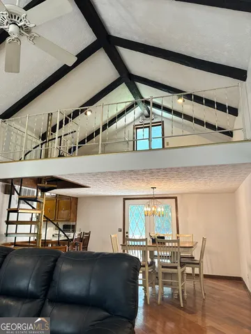 a view of a dining room with furniture and wooden floor