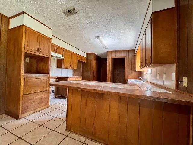 a kitchen with stainless steel appliances a sink and a refrigerator