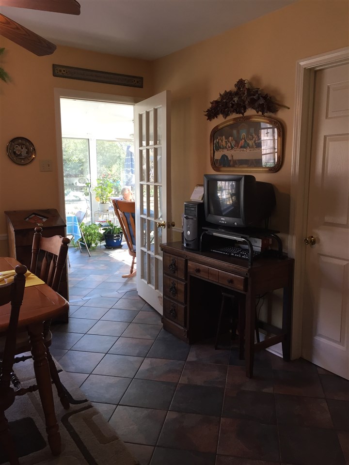 1464 Walton Road Memphis, TN 38117 - Photo 12 of 25 a living room with furniture a piano and a floor to ceiling window