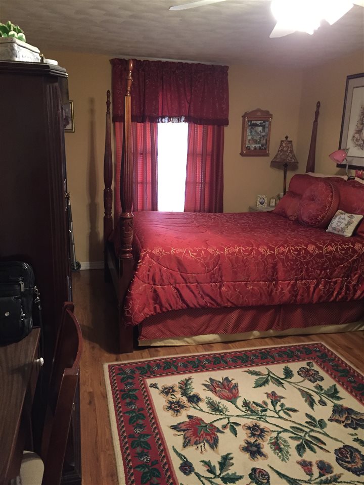 1464 Walton Road Memphis, TN 38117 - Photo 17 of 25 a bedroom with a bed and wooden floor
