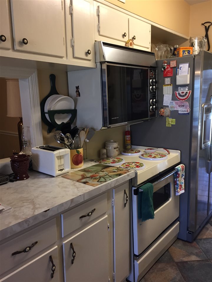 1464 Walton Road Memphis, TN 38117 - Photo 5 of 25 a kitchen with stainless steel appliances granite countertop a sink and a stove