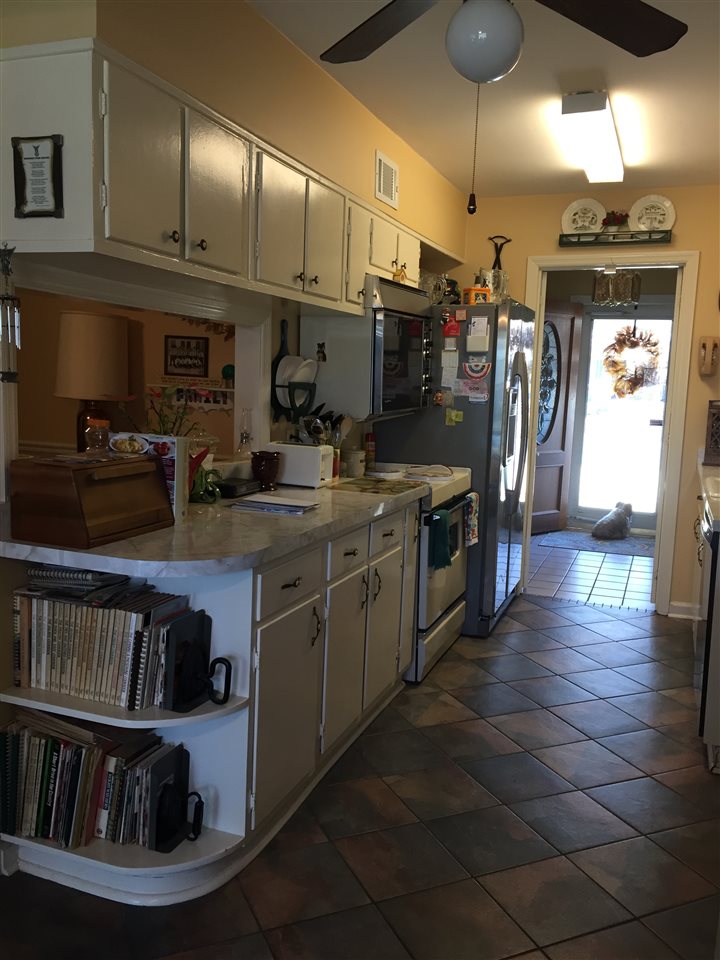 1464 Walton Road Memphis, TN 38117 - Photo 7 of 25 a kitchen with stainless steel appliances granite countertop a refrigerator a stove and a sink