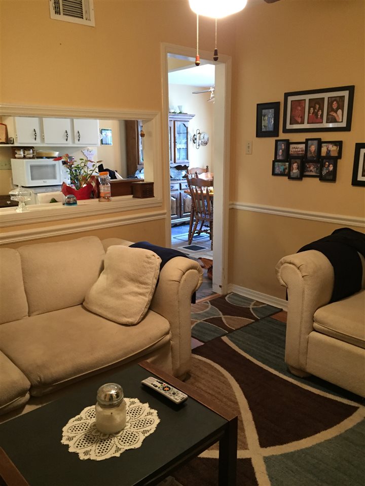 1464 Walton Road Memphis, TN 38117 - Photo 9 of 25 a living room with furniture and painting on the wall