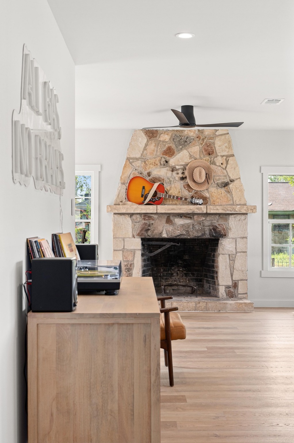 3501 Pecan Springs Road Austin, TX 78723 - Photo 27 of 40 Living area featuring a fireplace, light wood-style floors, plenty of natural light, recessed lighting, and ceiling fan