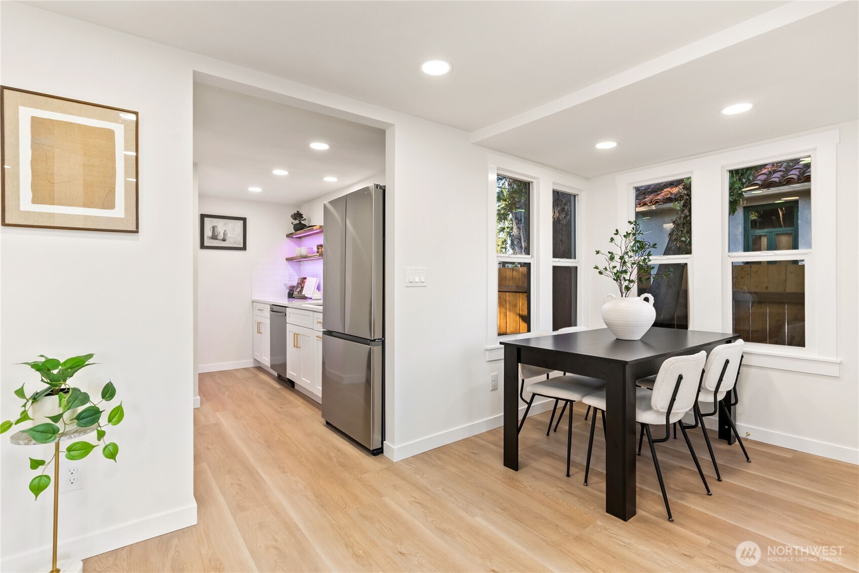 7310 35th Avenue Southwest Seattle, WA 98126 - Photo 13 of 39 a view of a dining room with furniture and a potted plant