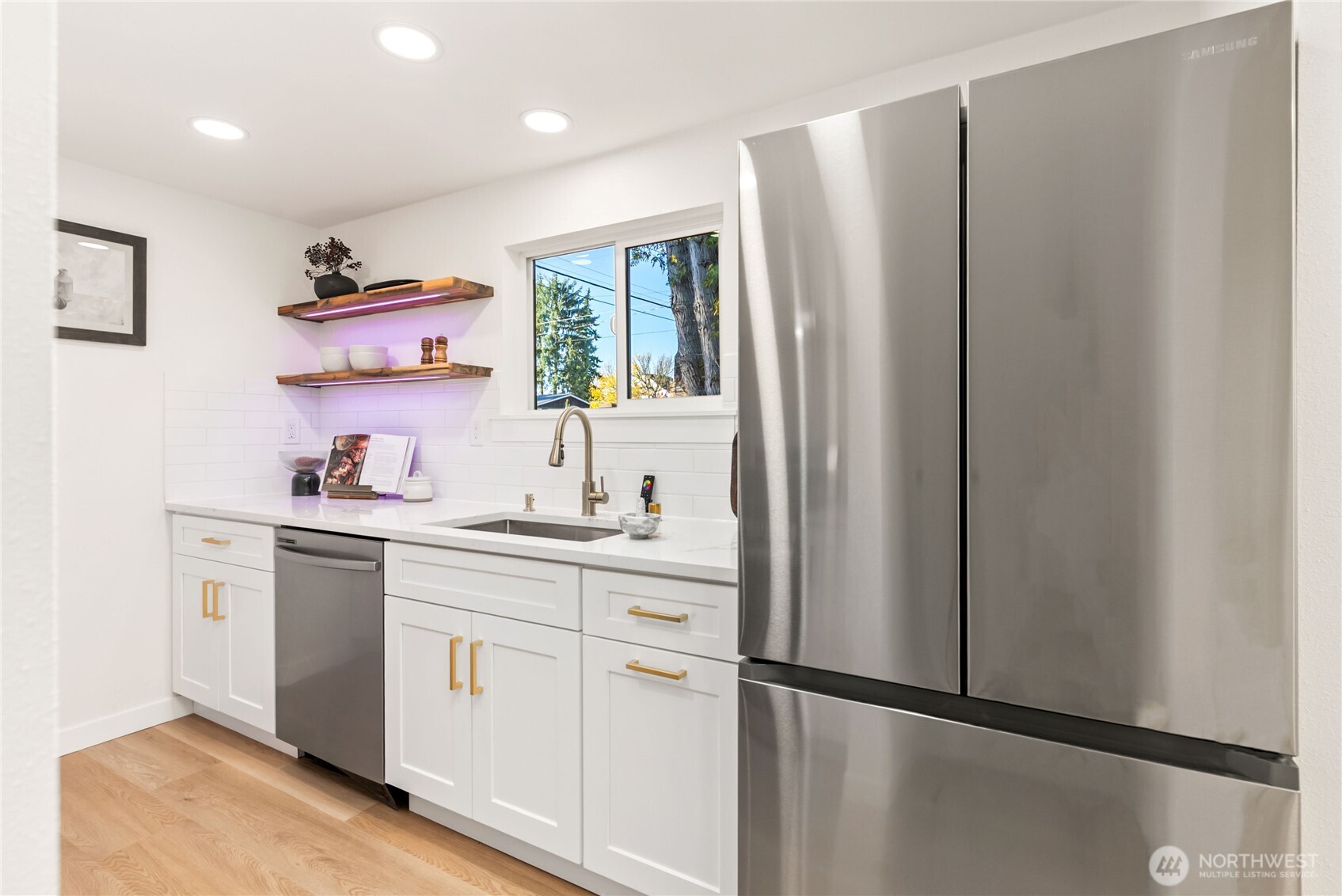 7310 35th Avenue Southwest Seattle, WA 98126 - Photo 14 of 39 a kitchen with stainless steel appliances a refrigerator sink and cabinets
