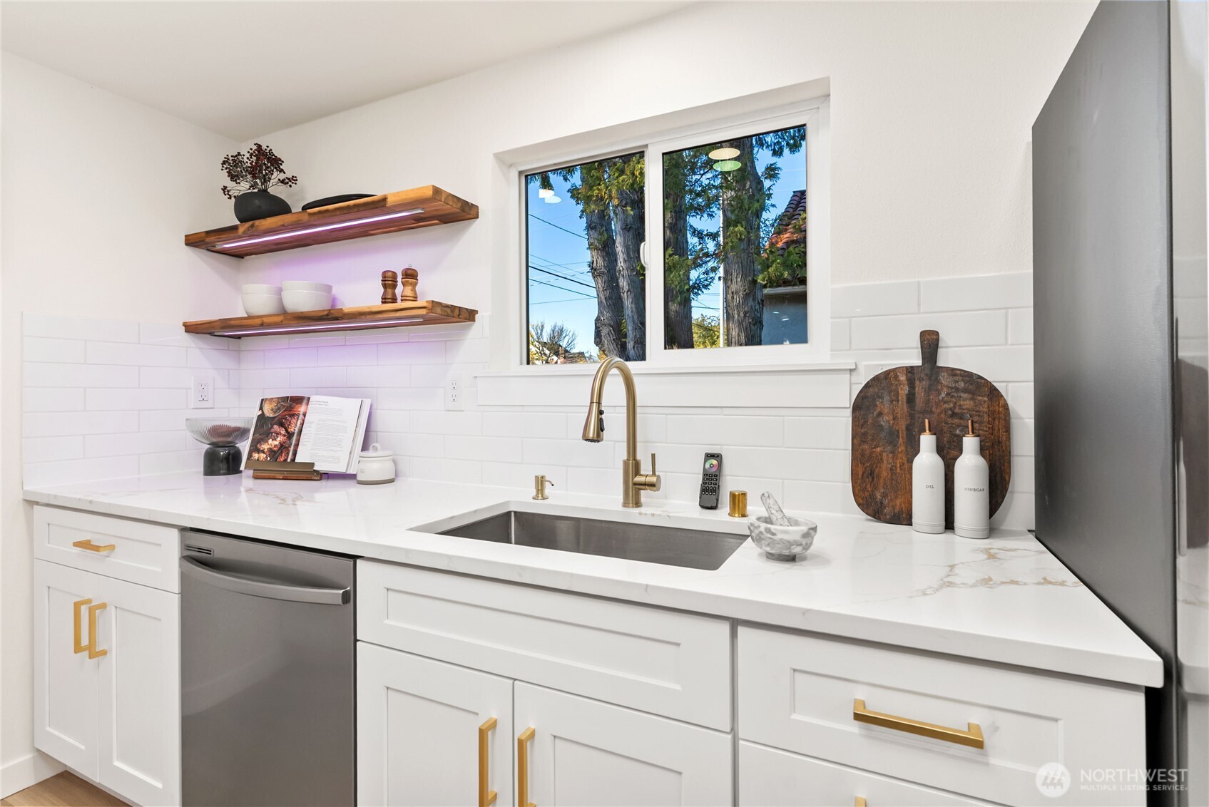7310 35th Avenue Southwest Seattle, WA 98126 - Photo 15 of 39 a kitchen with a sink a stove and cabinets