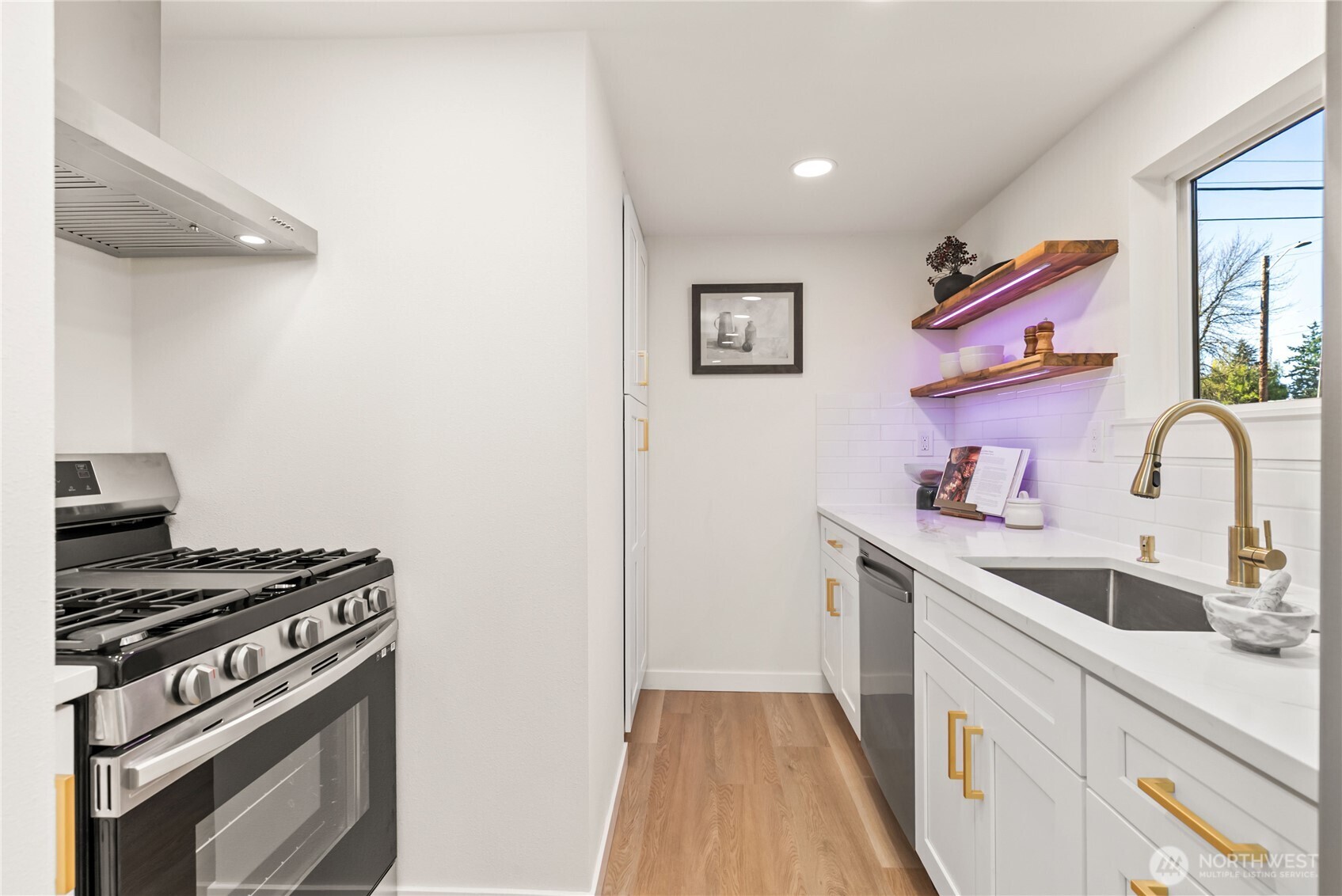 7310 35th Avenue Southwest Seattle, WA 98126 - Photo 16 of 39 a kitchen with a stove and a sink
