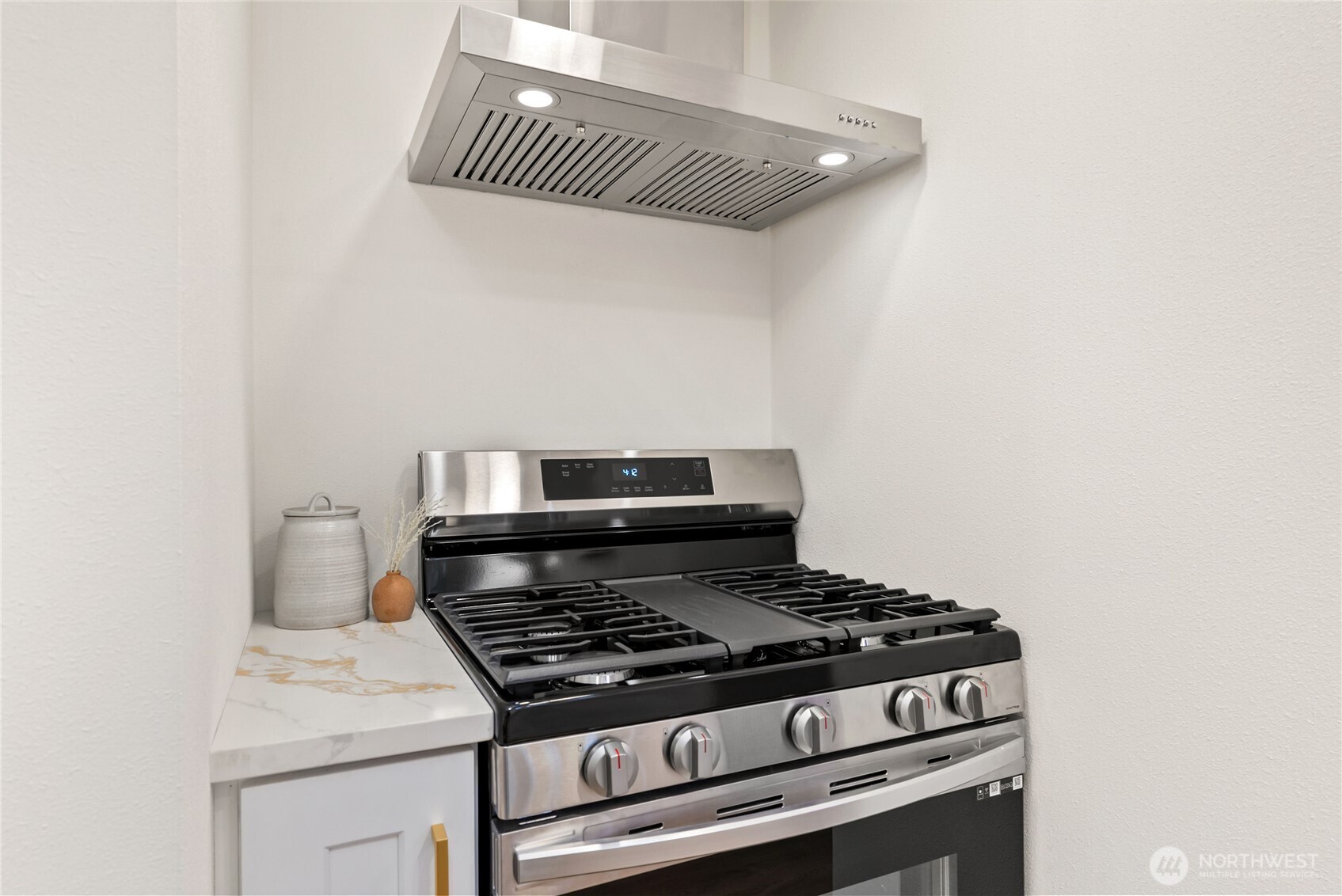 7310 35th Avenue Southwest Seattle, WA 98126 - Photo 17 of 39 a stove top oven sitting inside of a kitchen