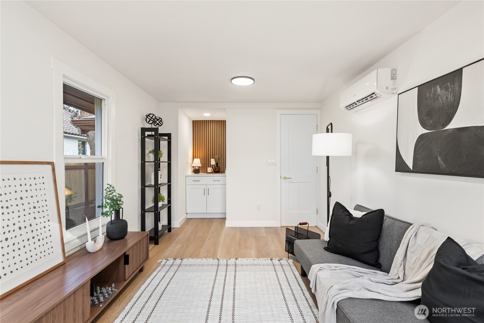 7310 35th Avenue Southwest Seattle, WA 98126 - Photo 25 of 39 a bedroom with a bed and wooden floor