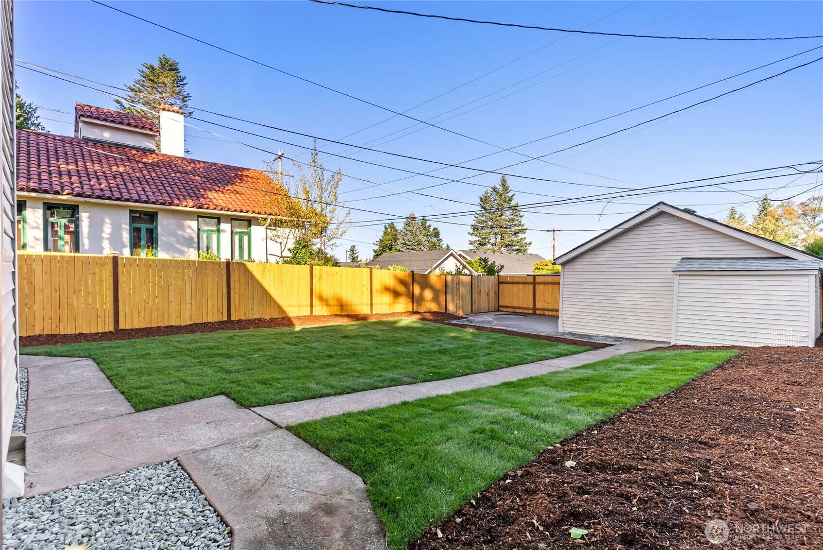 7310 35th Avenue Southwest Seattle, WA 98126 - Photo 29 of 39 a front view of a house with a yard and garage