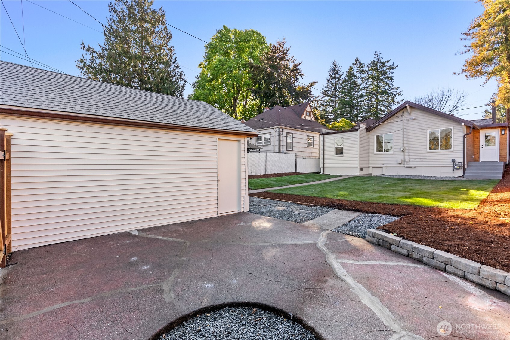 7310 35th Avenue Southwest Seattle, WA 98126 - Photo 32 of 39 a view of a house with a yard and garage