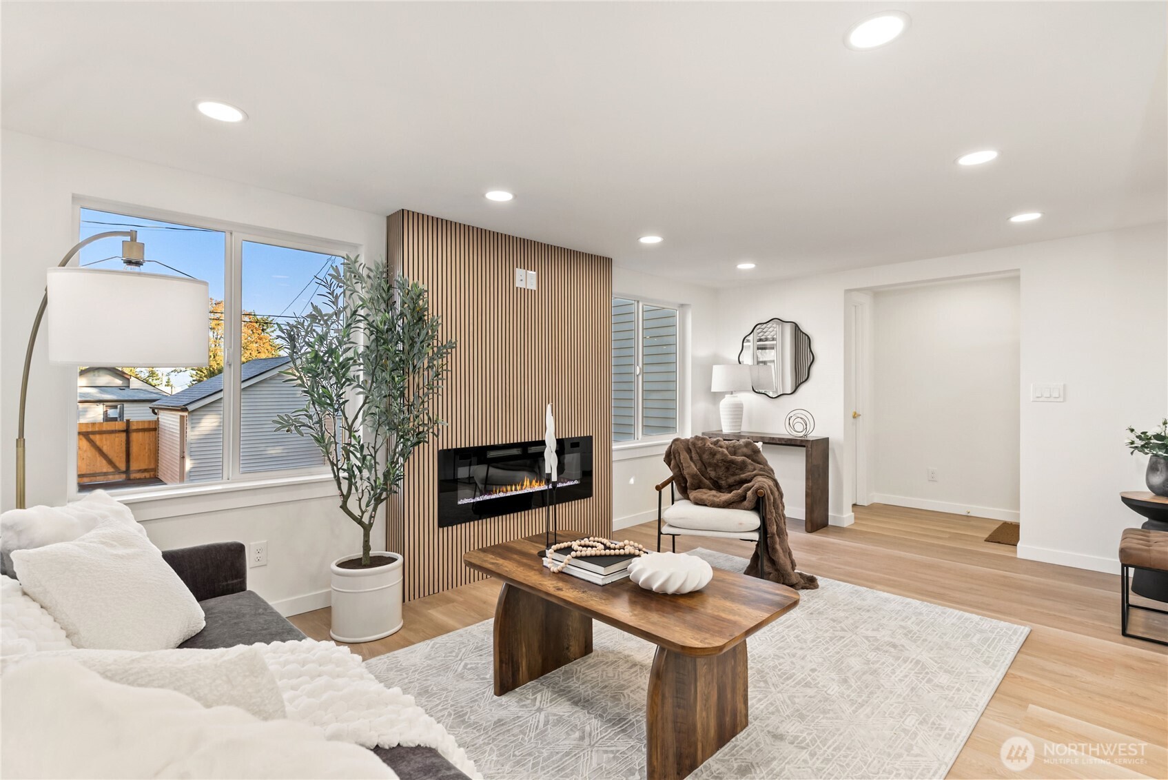 7310 35th Avenue Southwest Seattle, WA 98126 - Photo 7 of 39 a living room with furniture a fireplace and a potted plant
