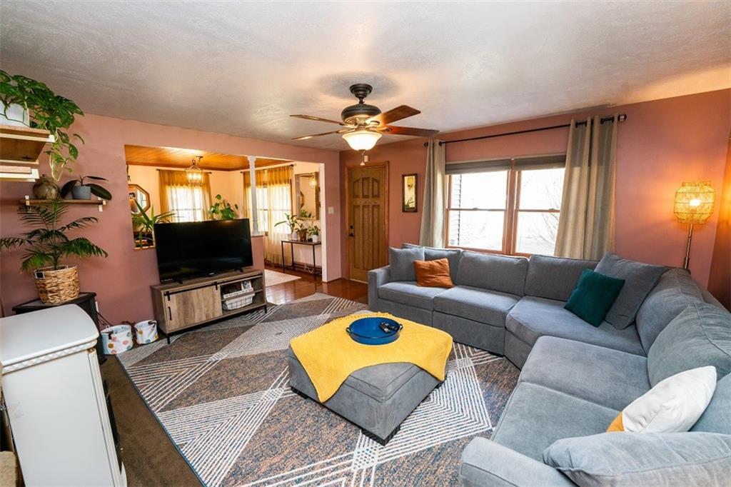 232 Lighthouse Road Commodore, PA 15729 - Photo 2 of 17 a living room with furniture a flat screen tv and a chandelier