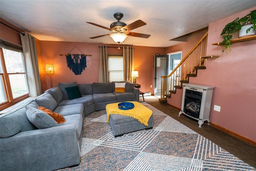 232 Lighthouse Road Commodore, PA 15729 - Photo 3 of 17 a living room with furniture and a fireplace
