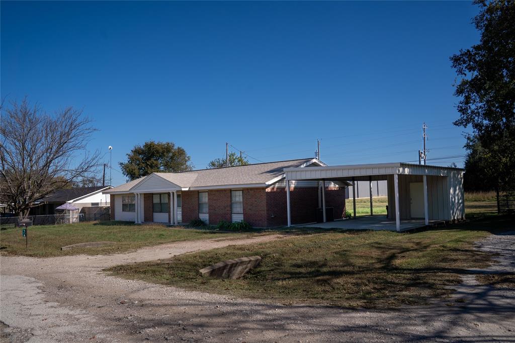 156 Wayman Drive Whitney, TX 76692 - Photo 2 of 17 a front view of a house with a garden