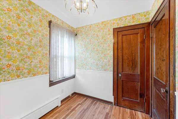 a view of front door with wooden floor