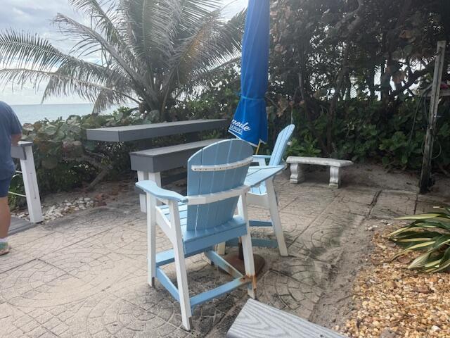5520 North Ocean Boulevard, Unit 111 Ocean Ridge, FL 33435 - Photo 50 of 63 a view of backyard with a table and chairs