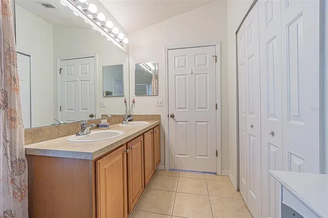 a bathroom with a sink a mirror and a vanity
