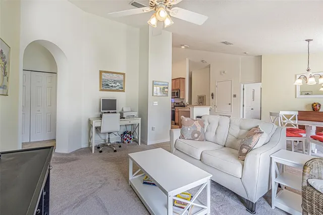 a living room with furniture and a chandelier