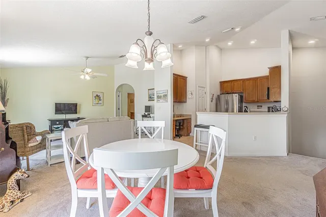 a view of a dining room with furniture and chandelier