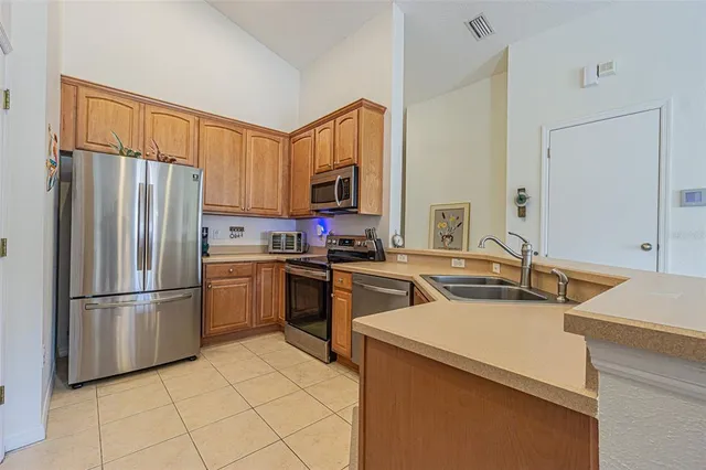 a kitchen with a refrigerator sink and cabinets