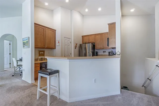 a kitchen with stainless steel appliances kitchen island granite countertop a stove a sink and a microwave