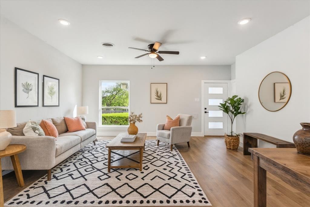 a living room with furniture a chandelier and a window