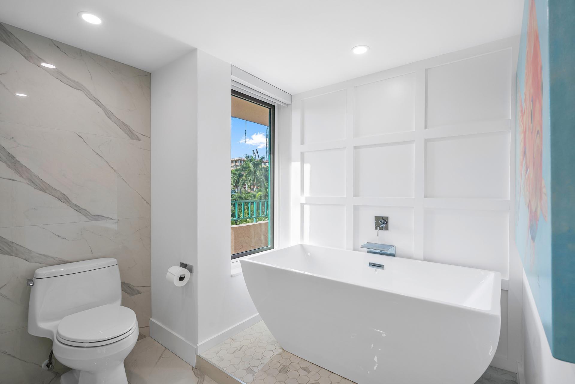 100 Southeast 5th Avenue, Unit 416 Boca Raton, FL 33432 - Photo 20 of 42 a white bath tub sitting next to a toilet