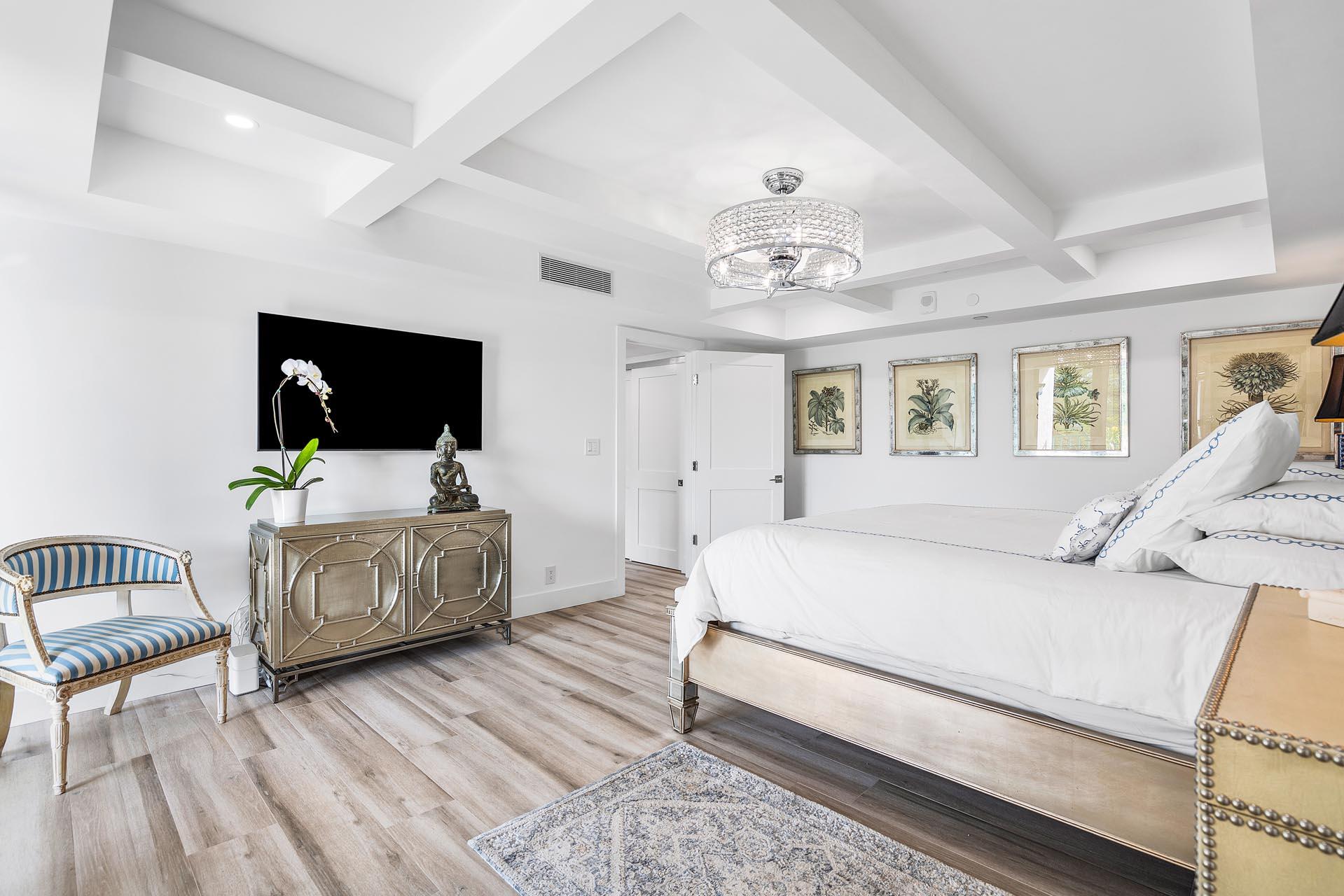 100 Southeast 5th Avenue, Unit 416 Boca Raton, FL 33432 - Photo 21 of 42 a bedroom with a bed and a flat screen tv