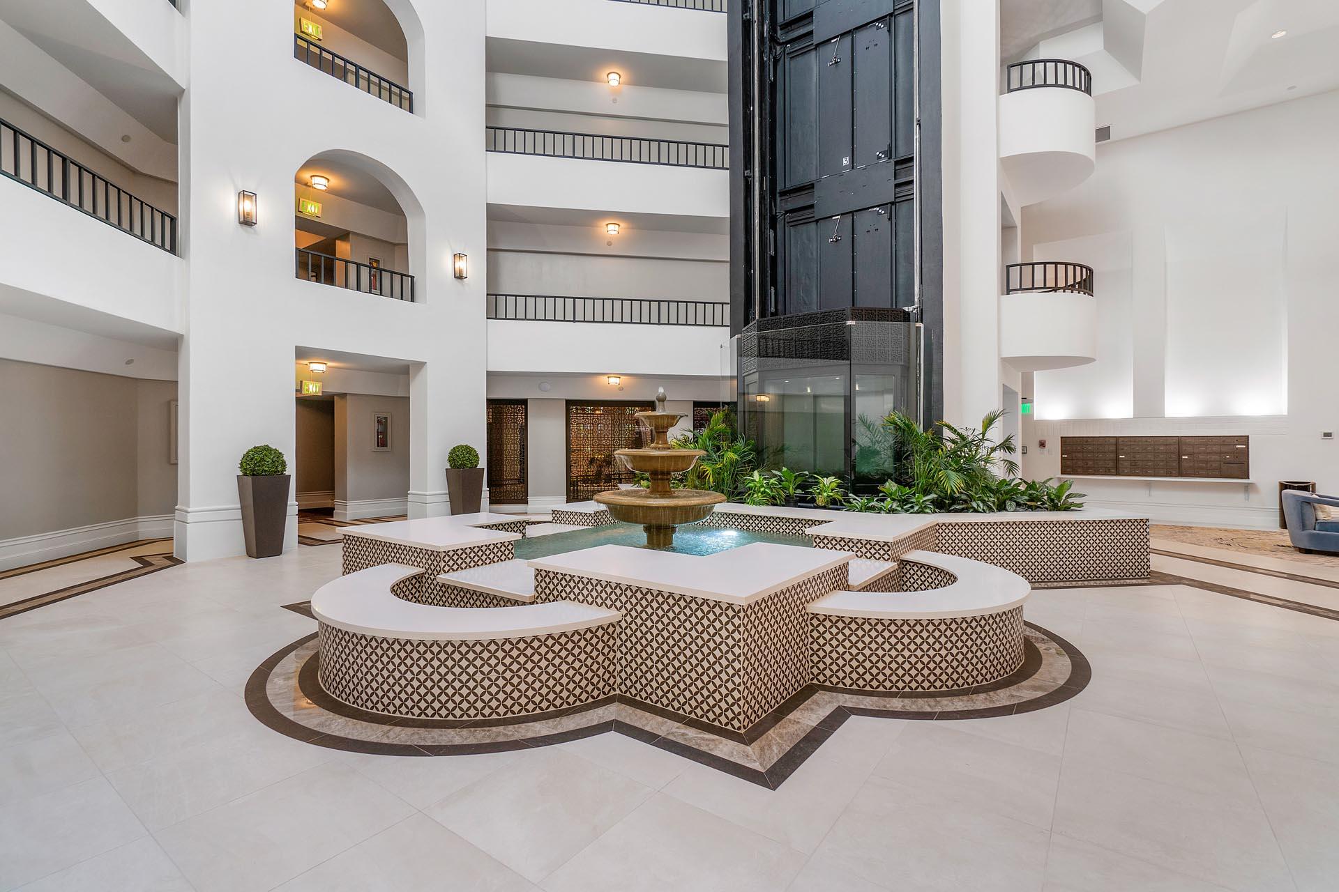 100 Southeast 5th Avenue, Unit 416 Boca Raton, FL 33432 - Photo 30 of 42 a living room with fireplace furniture and a potted plant