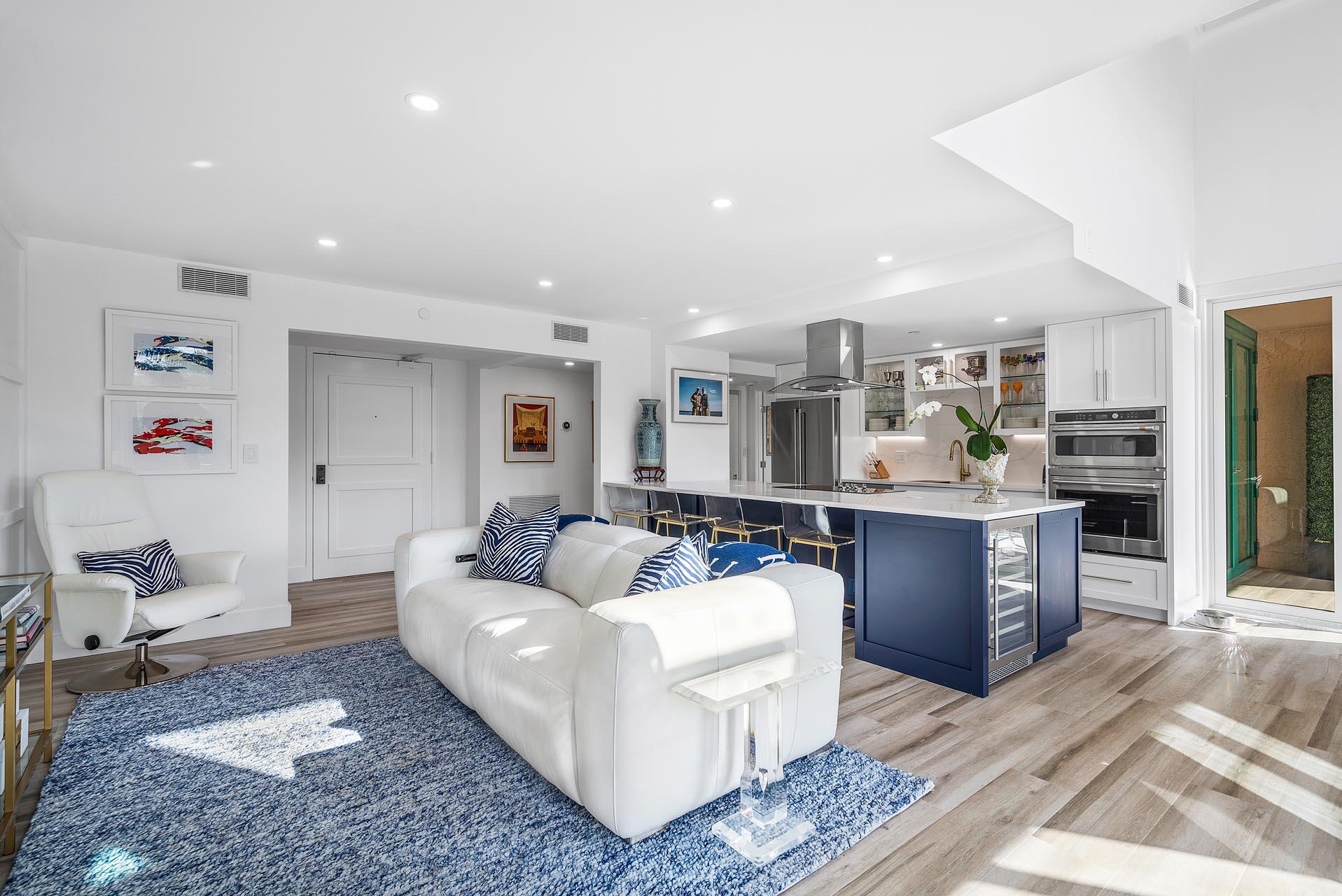 100 Southeast 5th Avenue, Unit 416 Boca Raton, FL 33432 - Photo 6 of 42 a living room with stainless steel appliances furniture a rug and a kitchen view