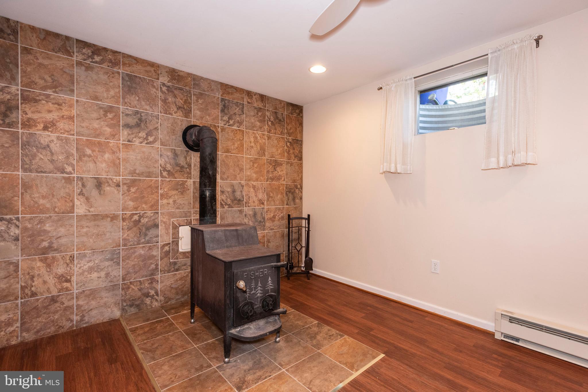 10527 Rum Springs Road Frederick, MD 21702 - Photo 22 of 39 Lower Level Rec Room w/ Wood Burning Stove