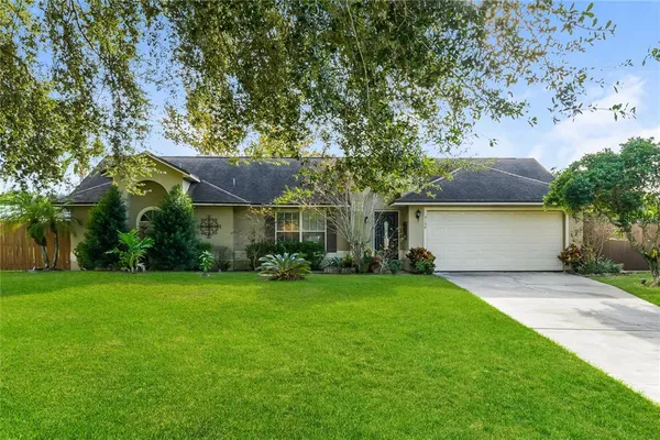 a front view of house with yard and green space