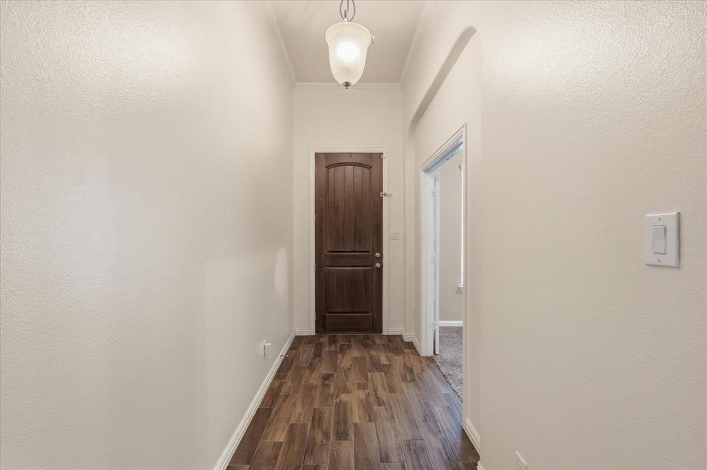 215 Equestrian Road Hickory Creek, TX 75065 - Photo 5 of 36 a view of a hallway with wooden floor and a bathroom